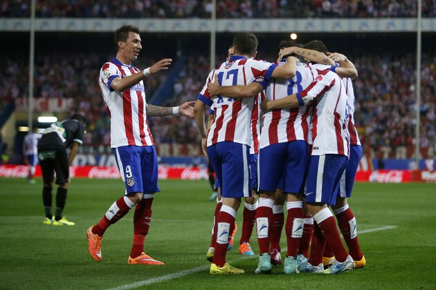 Atletico's Raul Garcia, center, celebrates his goal with teammates during a Spanish La Liga soccer match between Atletico Madrid and Cordoba at the Vicente Calderon stadium in Madrid, Spain, Saturday, Nov. 1, 2014. (AP Photo/Andres Kudacki)