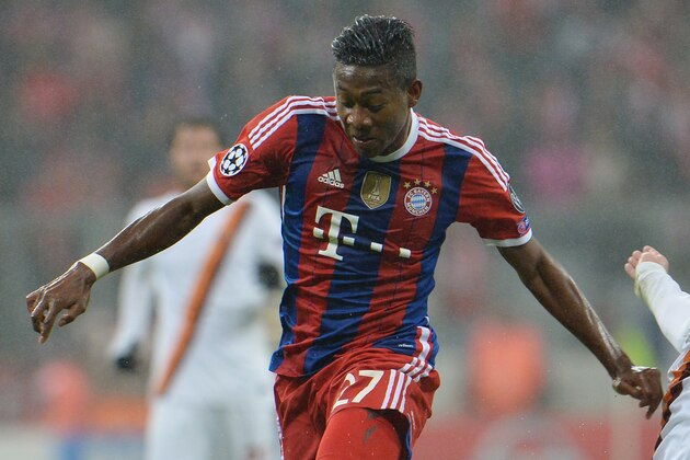 Bayern's David Alaba, left, and Roma's Daniele De Rossi challenge for the ball during the Champions League group E soccer match between Bayern Munich and Roma in Munich, Germany, on Wednesday, Nov. 05, 2014. (AP Photo/Kerstin Joensson)