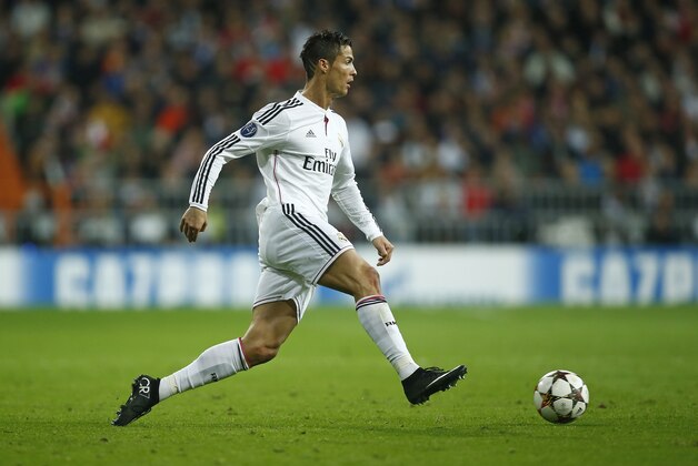 Real Madrid's Cristiano Ronaldo runs with the ball during a Group B Champions League soccer match between Real Madrid and Liverpool at the Santiago Bernabeu stadium in Madrid, Spain, Tuesday Nov. 4, 2014. (AP Photo/Andres Kudacki)