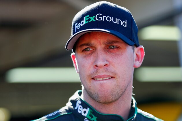 AVONDALE, AZ - NOVEMBER 07: Denny Hamlin, driver of the #11 FedEx Ground Toyota, stands in the garage area during practice for the NASCAR Sprint Cup Series Quicken Loans Race for Heroes 500 at Phoenix International Raceway on November 7, 2014 in Avondale, Arizona.  (Photo by Tom Pennington/Getty Images)