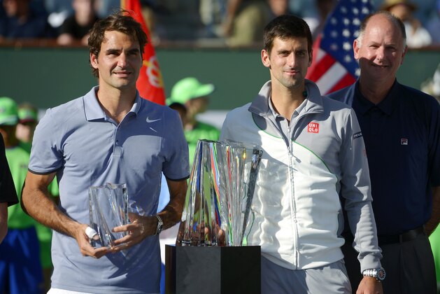 Novak Djokovic, right, of Serbia, and Roger Federer, of Switzerland, pose with their trophies after Djokovic beat Federer 3-6, 6-3, 7-6 to win the final match of the BNP Paribas Open tennis tournament, Sunday, March 16, 2014, in Indian Wells, Calif. (AP Photo/Mark J. Terrill)