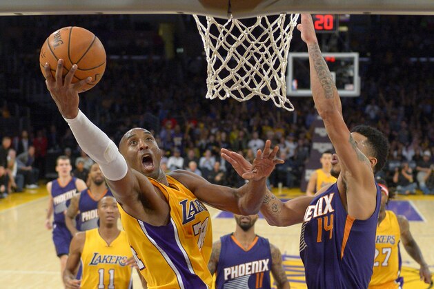 Los Angeles Lakers guard Kobe Bryant shoots as Phoenix Suns guard Gerald Green defends during the second half of an NBA basketball game, Tuesday, Nov. 4, 2014, in Los Angeles. The Suns won 112-106. (AP Photo/Mark J. Terrill)