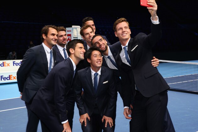 LONDON, ENGLAND - NOVEMBER 07: Tomas Berdych of the Czech Republic takes a group selfie of Stan Wawrinka of Switzerland,Milos Raonic of Canada,Novak Djokovic of Serbia,Kei Nishikori of Japan,Andy Murray of Great Britain,Roger Federer of Switzerland and Marin Cilic of Croatia after the mens singles official group shot had been taken prior to the start of  the Barclays ATP World Tour Finals tennis previews at the O2 Arena  on November 7, 2014 in London, England.  (Photo by Clive Brunskill/Getty Images)