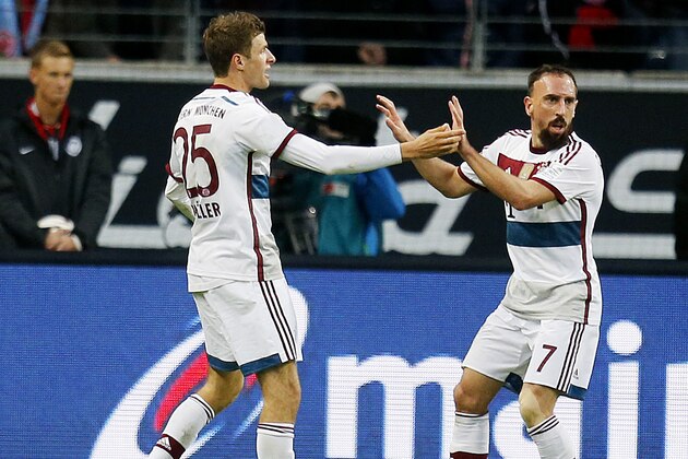 Bayern's Thomas Mueller, left, celebrates his side's second goal with team mate Franck Ribery during the German first division Bundesliga soccer match between Eintracht Frankfurt and Bayern Munich in the Commerzbank Arena in Frankfurt, Germany, Saturday, Nov. 8, 2014. (AP Photo/Michael Probst)