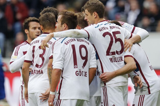 Munich players celebrate their side's opening goal during the German first division Bundesliga soccer match between Eintracht Frankfurt and Bayern Munich in the Commerzbank Arena in Frankfurt, Germany, Saturday, Nov. 8, 2014. (AP Photo/Michael Probst)