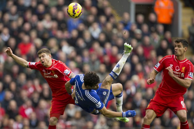 Liverpool's Chelsea's Diego Costa, center, attempts an overhead kick as Liverpool's Alberto Moreno, left, and Dejan Lovren look on during the English Premier League soccer match between Liverpool and Chelsea at Anfield Stadium, Liverpool, England, Saturday Nov. 8, 2014. (AP Photo/Jon Super)