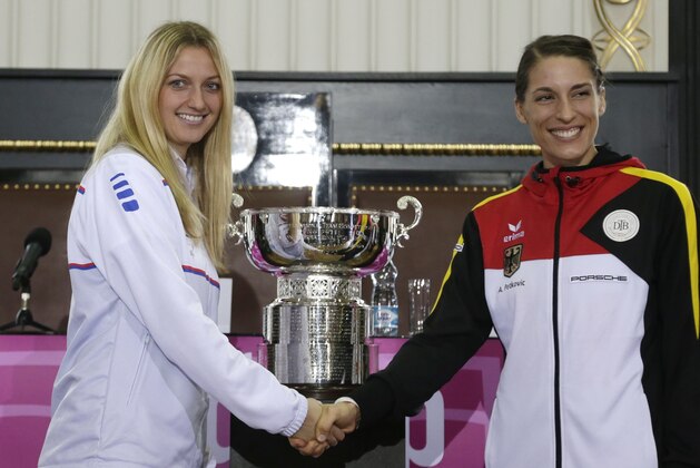 Czech Republic's Petra Kvitova, left, poses for a photo with Germany's Andrea Petkovic, right, after a draw for the  Fed Cup tennis  Final  between Czech Republic and Germany in Prague, Czech Republic, Friday, Nov. 7, 2014. (AP Photo/Petr David Josek)