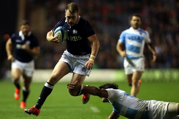 Scotland's Stuart Hogg, left, goes on to score a try  past Argentina's Manuel Montero , right, during the international rugby match at Murrayfield, Edinburgh, Scotland, Saturday Nov. 8, 2014. (AP Photo/Scott Heppell)