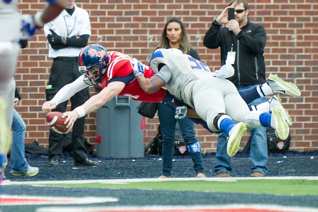 OXFORD, MS - NOVEMBER 8: Quarterback Bo Wallace #14 of the Mississippi Rebels dives in front of linebacker Donelle Williams #32 of the Presbyterian Blue Hose for a touchdown on November 8, 2014 at Vaught-Hemingway Stadium in Oxford, Mississippi. At halftime the Mississippi Rebels leads the Presbyterian Blue Hose 35-0. (Photo by Michael Chang/Getty Images)