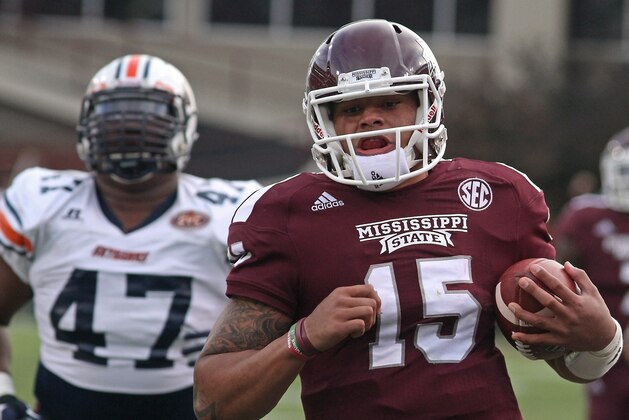 Mississippi State quarterback Dak Prescott (15) sprints into the end zone for a touchdown ahead of UT-Martin defender Deantae Glover (47) during the first half of an NCAA college football game in Starkville, Miss., Saturday, Nov. 8, 2014. (AP Photo/Jim Lytle)