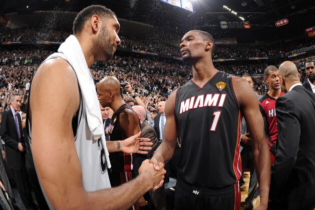 SAN ANTONIO, TX - JUNE 15: Tim Duncan #21 of the San Antonio Spurs and Chris Bosh #1 of the Miami Heat shake hands after the San Antonio Spurs' victory in Game Five and winning the 2014 NBA Finals between the Miami Heat and San Antonio Spurs at AT&T Center on June 15, 2014 in San Antonio, Texas. NOTE TO USER: User expressly acknowledges and agrees that, by downloading and/or using this photograph, user is consenting to the terms and conditions of the Getty Images License Agreement.  Mandatory Copyright Notice: Copyright 2014 NBAE (Photo by Andrew D Bernstein/NBAE via Getty Images)