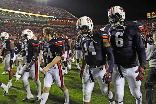 Nov 8, 2014; Auburn, AL, USA; Auburn Tigers quarterback Nick Marshall (14) and quarterback Jeremy Johnson (6) walk off the field after the game against the Texas A&M Aggies at Jordan Hare Stadium. Texas A&M won 41-38. Mandatory Credit: Shanna Lockwood-USA TODAY Sports