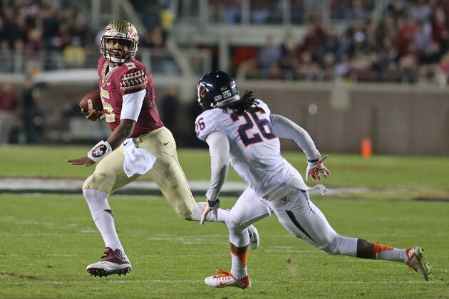 Florida State's Jameis Winston, left, evades Virginia's Maurice Canady to pick up yardage in the first quarter of an NCAA college football game, Saturday, Nov. 8, 2014, in Tallahassee, Fla. (AP Photo/Steve Cannon)