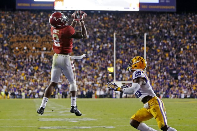 Alabama wide receiver DeAndrew White (2) pulls in a touchdown reception over LSU safety Jalen Mills (28) during overtime of an NCAA college football game in Baton Rouge, La., Saturday, Nov. 8, 2014. Alabama won 20-13. (AP Photo/Jonathan Bachman)