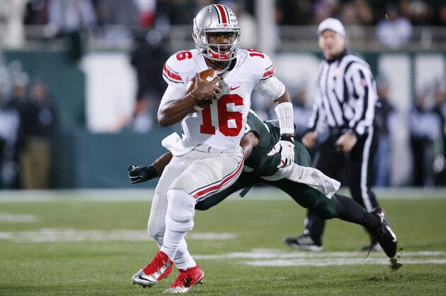 EAST LANSING, MI - NOVEMBER 8: J.T. Barrett #16 of the Ohio State Buckeyes runs with the ball in the first half of the game against the Michigan State Spartans at Spartan Stadium on November 8, 2014 in East Lansing, Michigan. (Photo by Joe Robbins/Getty Images)