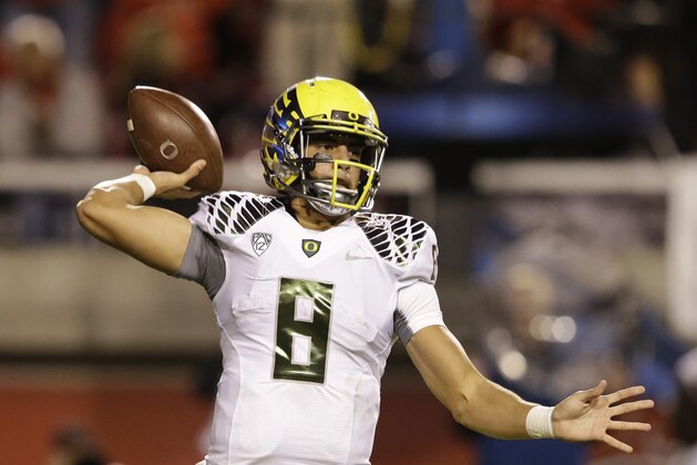 Oregon quarterback Marcus Mariota (8) passes the ball in the second half during an NCAA college football game against Utah Saturday, Nov. 8, 2014, in Salt Lake City. (AP Photo/Rick Bowmer)