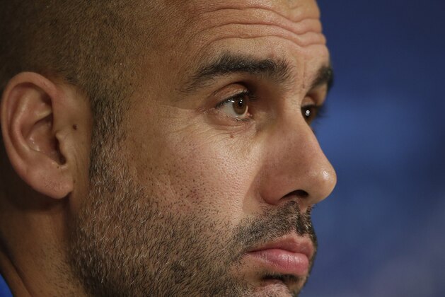 Bayern's head coach Pep Guardiola of Spain attends a news conference prior to the Champions League Group E soccer match between FC Bayern Munich and AS Roma at Allianz Arena in Munich, southern Germany, Tuesday Nov. 4, 2014. Bayern Munich will face Roma on Wednesday. (AP Photo/Matthias Schrader)