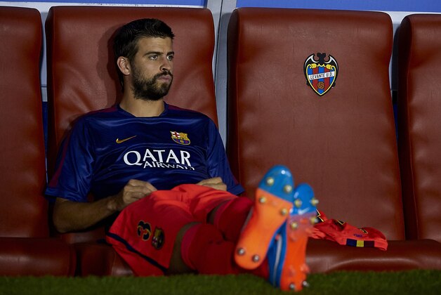 VALENCIA, SPAIN - SEPTEMBER 21:  Gerard Pique of Barcelona watches from the subsitute bench prior to the La Liga match between Levante UD and FC Barcelona at Ciutat de Valencia on September 21, 2014 in Valencia, Spain.  (Photo by Manuel Queimadelos Alonso/Getty Images)