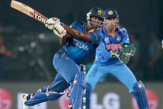 DHAKA, BANGLADESH - APRIL 06:  Thisara Perera of Sri Lanka hits the winning runs as MS Dhoni of India looks on during the Final of the ICC World Twenty20 Bangladesh 2014 between India and Sri Lanka at Sher-e-Bangla Mirpur Stadium on April 4, 2014 in Dhaka, Bangladesh.  (Photo by Scott Barbour/Getty Images)