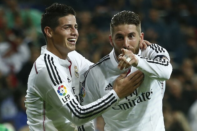 Real's Sergio Ramos, right, celebrates his goal with teammate James Rodriguez during a Spanish La Liga soccer match between Rayo Vallecano and Real Madrid at the Santiago Bernabeu stadium in Madrid, Spain, Saturday, Nov. 8, 2014. (AP Photo/Andres Kudacki)