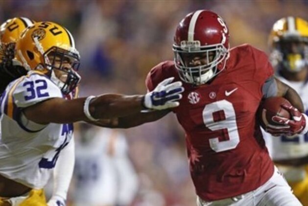 Alabama wide receiver Amari Cooper (9) eludes LSU cornerback Jalen Collins (32) on a 23 yard touchdown reception in the first half of an NCAA college football game in Baton Rouge, La., Saturday, Nov. 8, 2014. (AP Photo/Jonathan Bachman)
