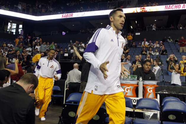 Los Angeles Lakers guard Steve Nash runs out onto the court for a preseason NBA basketball game against the Golden State Warriors, Sunday, Oct. 12, 2014, in Ontario, Calif. (AP Photo/Alex Gallardo)