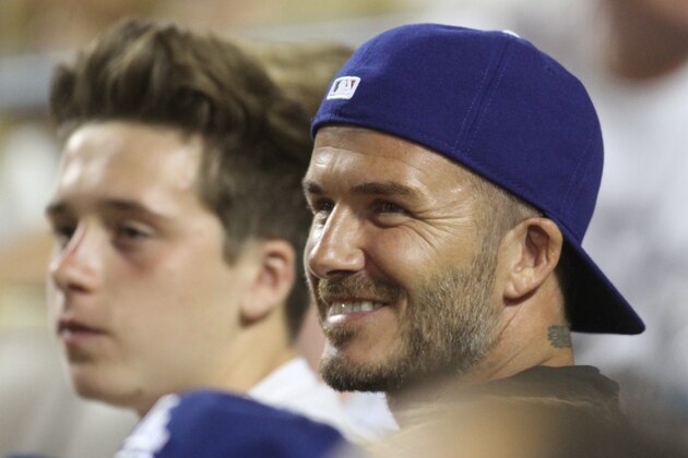 David Beckham and his three sons, Brooklyn, Romeo and Cruz enjoy a boys night out at the Los Angeles Dodgers Baseball game at Dodger stadium in Los Angeles, Ca 1 August 2014. UK clients should be aware children's faces may need pixelating. David Beckham and his three sons, Brooklyn, Romeo and Cruz enjoy a boys night out at the Los Angeles Dodgers Baseball game at Dodger stadium in Los Angeles, Ca 1 August 2014. UK clients should be aware children's faces may need pixelating. Vantage News/IPx