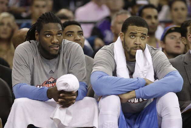 Denver Nuggets' Kenneth Faried, left, and JaVale McGee watch the team's NBA basketball game against the Sacramento Kings in Sacramento, Calif., Wednesday, Nov. 5, 2014. The Kings won 131-109. (AP Photo/Rich Pedroncelli)