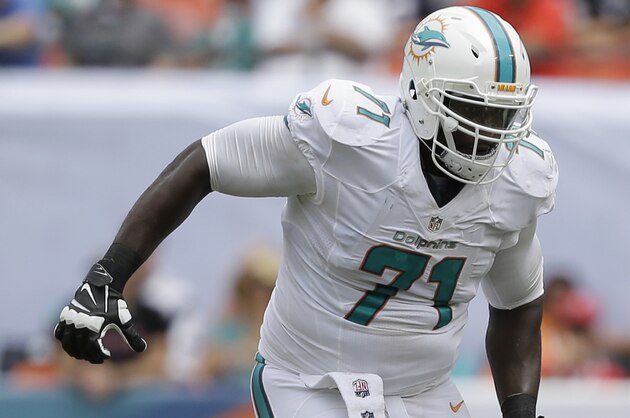 Miami Dolphins tackle Branden Albert (71) runs on the field during the first half of an NFL football game against the New England Patriots, in Miami Gardens, Fla., Sunday Sept. 7, 2014. (AP Photo/Wilfredo Lee)