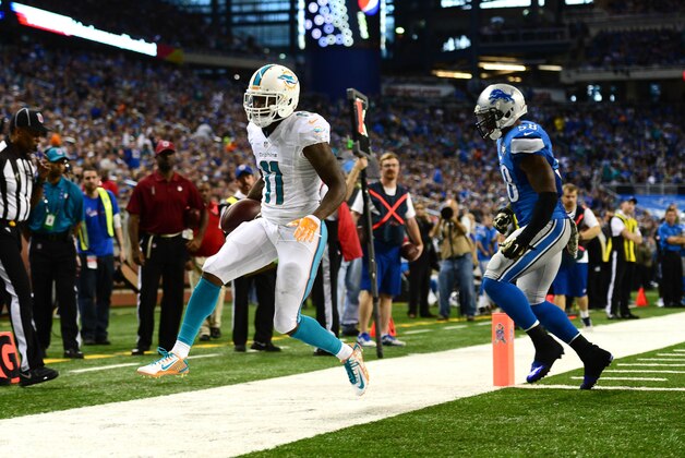 Nov 9, 2014; Detroit, MI, USA; Miami Dolphins wide receiver Mike Wallace (11) runs the ball into the end zone for a touchdown during the third quarter against the Detroit Lions at Ford Field. Mandatory Credit: Andrew Weber-USA TODAY Sports