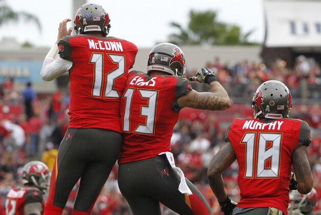 Nov 9, 2014; Tampa, FL, USA; Tampa Bay Buccaneers wide receiver Mike Evans (13) is congratulated by quarterback Josh McCown (12) after he scores a touchdown against the Atlanta Falcons during the second quarter at Raymond James Stadium. Mandatory Credit: Kim Klement-USA TODAY Sports