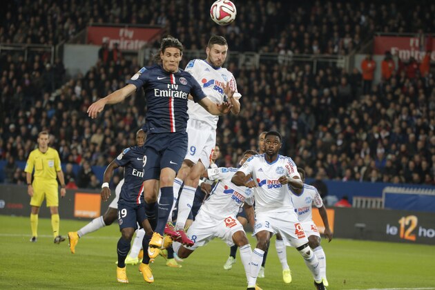 Paris Saint Germain's Edinson Cavani, left, challenge to head the ball with Marseille's Andre-Pierre Gignac during their French League One soccer match match between Paris Saint Germain and Marseille at Parc des Princes stadium in Paris, France, Sunday, Nov. 9, 2014. (AP Photo/Francois Mori)