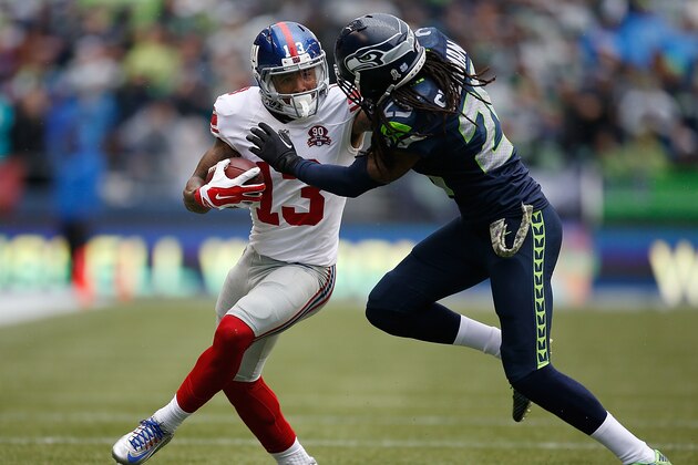 SEATTLE, WA - NOVEMBER 09:  Wide receiver Odell Beckham Jr. #13 of the New York Giants gives cornerback Richard Sherman #25 of the Seattle Seahawks a stiff arm during the second quarter of the game at CenturyLink Field on November 9, 2014 in Seattle, Washington.  (Photo by Otto Greule Jr/Getty Images)