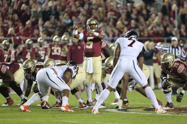 Florida State's Jameis Winston checks out the Virginia defense in an NCAA college football game, Saturday, Nov. 8, 2014, in Tallahassee, Fla. Florida State won the game 34-20. (AP Photo/Steve Cannon)