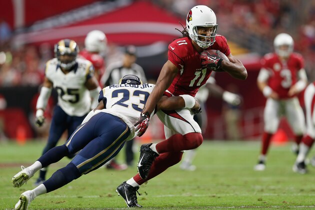 GLENDALE, AZ - NOVEMBER 09:  Wide receiver Larry Fitzgerald #11 of the Arizona Cardinals runs with the football under pressure from free safety Rodney McLeod #23 of the St. Louis Rams during the first half of the NFL game at the University of Phoenix Stadium on November 9, 2014 in Glendale, Arizona.  (Photo by Christian Petersen/Getty Images)