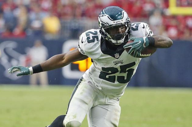 FILE - In this Nov. 2, 2014, file photo, Philadelphia Eagles running back LeSean McCoy (25) eludes a Houston Texans defender during the fourth quarter of an NFL football game in Houston. After leading the NFL with a franchise-record 1,607 yards rushing in 2013, McCoy ran for only 192 yards and averaged just 2.7 yards per carry in the first month for Philadelphia. McCoy responded with 430 yards in the next four games, including 117 in Sunday's win at Houston. (AP Photo/Tony Gutierrez, File)