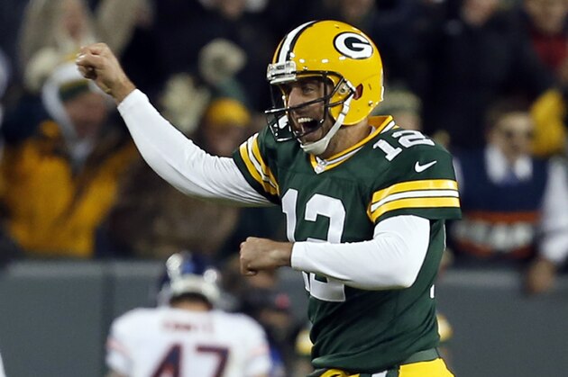 Green Bay Packers quarterback Aaron Rodgers (12) celebrates a touchdown during the first half of an NFL football game against the Chicago Bears Sunday, Nov. 9, 2014, in Green Bay, Wis. (AP Photo/Mike Roemer)