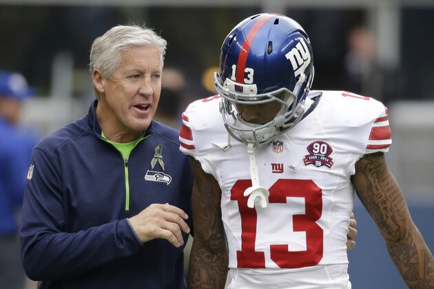 Seattle Seahawks head coach Pete Carroll, left, talks with New York Giants wide receiver Odell Beckham (13) during warmups before an NFL football game, Sunday, Nov. 9, 2014, in Seattle. (AP Photo/Elaine Thompson)