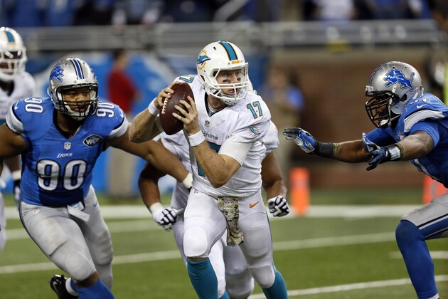 Miami Dolphins quarterback Ryan Tannehill (17) scrambles from Detroit Lions defensive tackle Ndamukong Suh (90) and Jason Jones (91) in the fourth quarter of a NFL football game in Detroit Sunday, Nov. 9, 2014. Detroit won 20-16. (AP Photo/Paul Sancya)