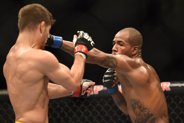 July 26, 2014; San Jose, CA, USA; Josh Thomson (red gloves) is punched by Bobby Green (blue gloves) during the lightweight bout of the FOX UFC Saturday at SAP Center. Mandatory Credit: Kyle Terada-USA TODAY Sports