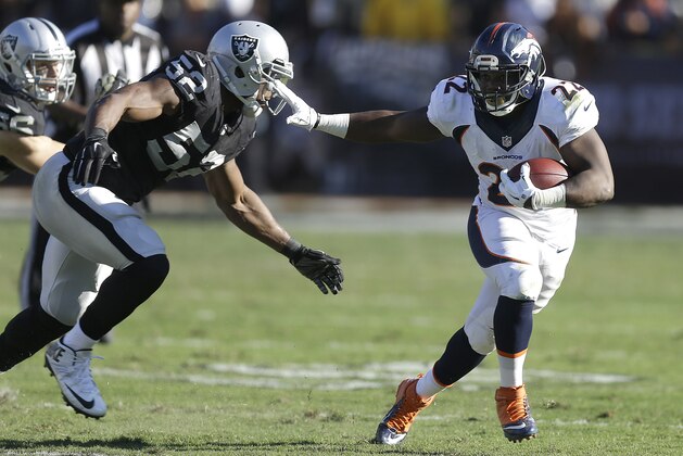 Denver Broncos running back C.J. Anderson (22) runs past Oakland Raiders outside linebacker Khalil Mack (52) to score on a 51-yard touchdown reception during the second quarter of an NFL football game in Oakland, Calif., Sunday, Nov. 9, 2014. (AP Photo/Ben Margot)