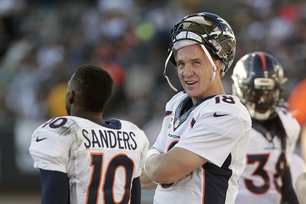 Denver Broncos quarterback Peyton Manning (18) stands on the sideline with wide receiver Emmanuel Sanders (10) during the fourth quarter of an NFL football game against the Oakland Raiders in Oakland, Calif., Sunday, Nov. 9, 2014. The Broncos won 41-17. (AP Photo/Marcio Jose Sanchez)