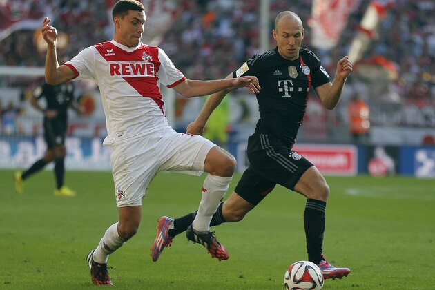 Cologne's Jonas Hector, left, and Bayern's Arjen Robben from the Netherlands challenge for the ball during the German first division Bundesliga soccer match between FC Cologne and Bayern Munich in Cologne, Germany, Saturday, Sept. 27, 2014. (AP Photo/Frank Augstein)