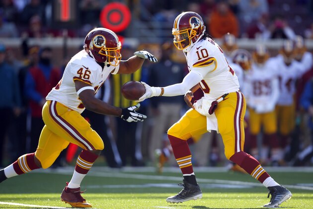 Washington Redskins quarterback Robert Griffin III (10) hands the ball off the running back Alfred Morris (46)l against the Minnesota Vikings during an NFL football game, Sunday, Nov. 2, 2014, in Minneapolis. (Jeff Haynes/AP Images for Panini)