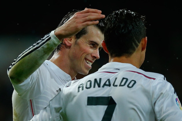 MADRID, SPAIN - NOVEMBER 08:  Cristiano Ronaldo (R) of Real Madrid CF celebrates scoring their fifth goal with teammate Gareth Bale (L) during the La Liga match between Real Madrid CF and Rayo Vallecano de Madrid at Estadio Santiago Bernabeu on November 8, 2014 in Madrid, Spain.  (Photo by Gonzalo Arroyo Moreno/Getty Images)