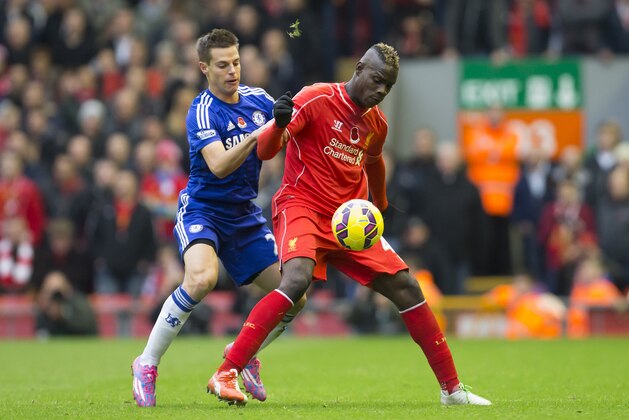 Liverpool's Mario Balotelli, center, fights for the ball against Chelsea's Cesar Azpilicueta during the English Premier League soccer match between Liverpool and Chelsea at Anfield Stadium, Liverpool, England, Saturday Nov. 8, 2014. (AP Photo/Jon Super)