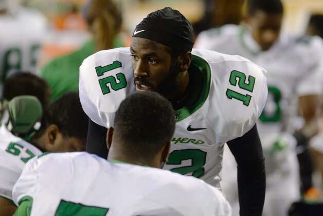 Marshall quarterback Rakeem Cato (12) talks to his teammates in the second half against Southern Miss during a NCAA college football game in Hattiesburg, Miss., Saturday, November 8, 2014. (AP Photo/Steve Coleman)
