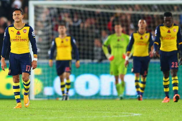 SWANSEA, WALES - NOVEMBER 09:  Alexis Sanchez of Arsenal (L) and team mates look dejected as they concede a goal during the Barclays Premier League match between Swansea City and Arsenal at Liberty Stadium on November 9, 2014 in Swansea, Wales.  (Photo by Michael Steele/Getty Images)