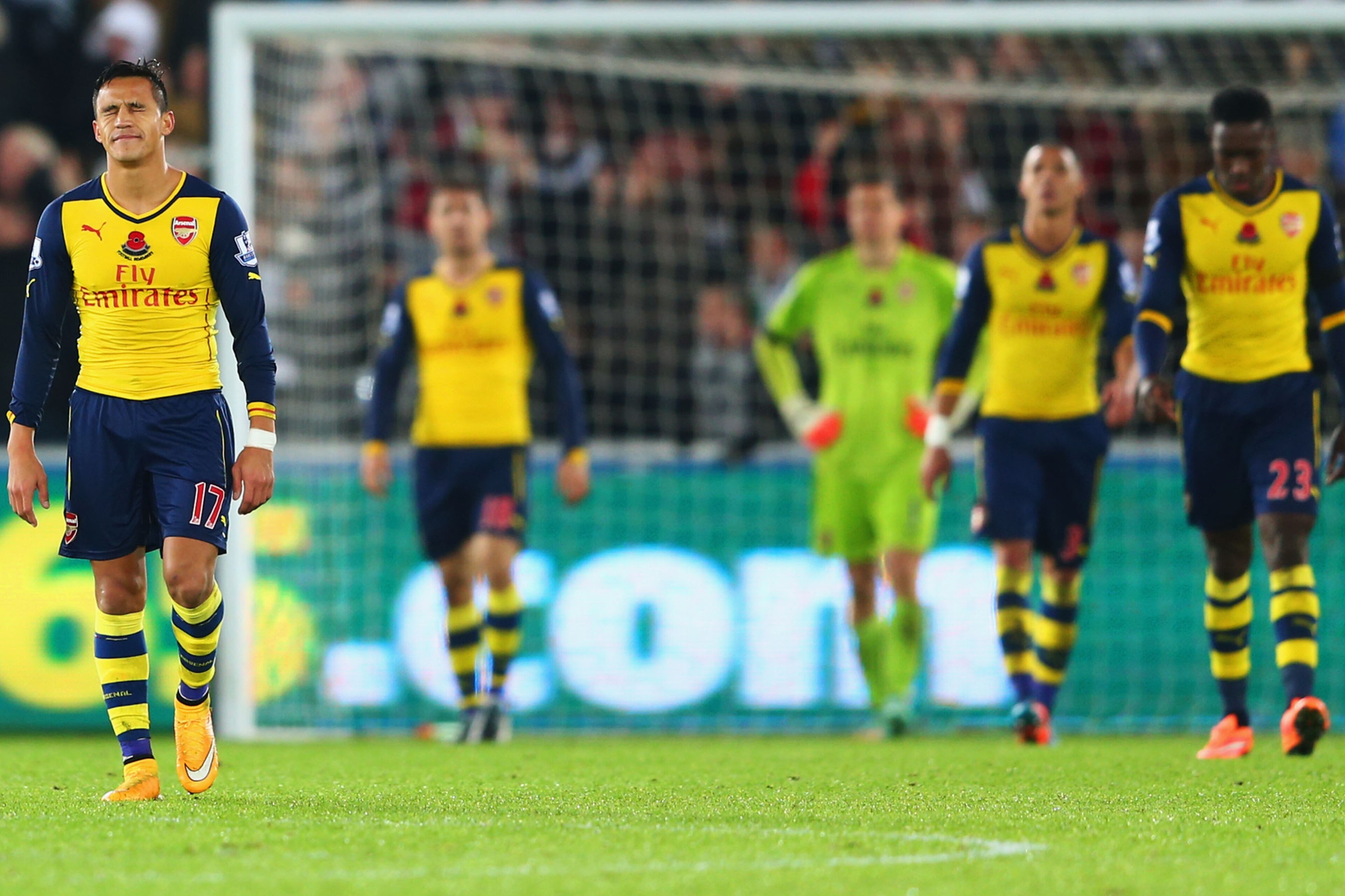 SWANSEA, WALES - NOVEMBER 09:  Alexis Sanchez of Arsenal (L) and team mates look dejected as they concede a goal during the Barclays Premier League match between Swansea City and Arsenal at Liberty Stadium on November 9, 2014 in Swansea, Wales.  (Photo by Michael Steele/Getty Images)