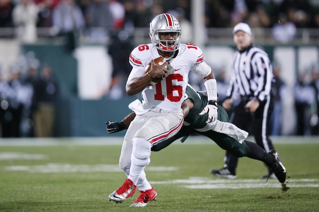 EAST LANSING, MI - NOVEMBER 8: J.T. Barrett #16 of the Ohio State Buckeyes runs with the ball in the first half of the game against the Michigan State Spartans at Spartan Stadium on November 8, 2014 in East Lansing, Michigan. (Photo by Joe Robbins/Getty Images)